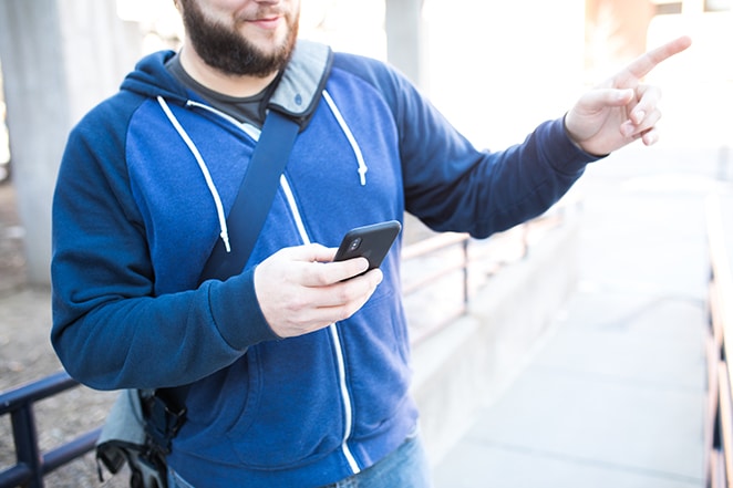 layout by flywheel responsive google map feature man on phone pointing in direction