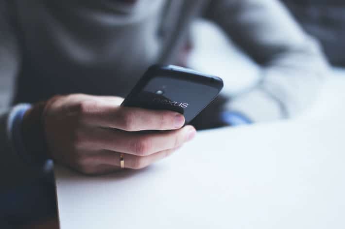 person scrolls on a smartphone