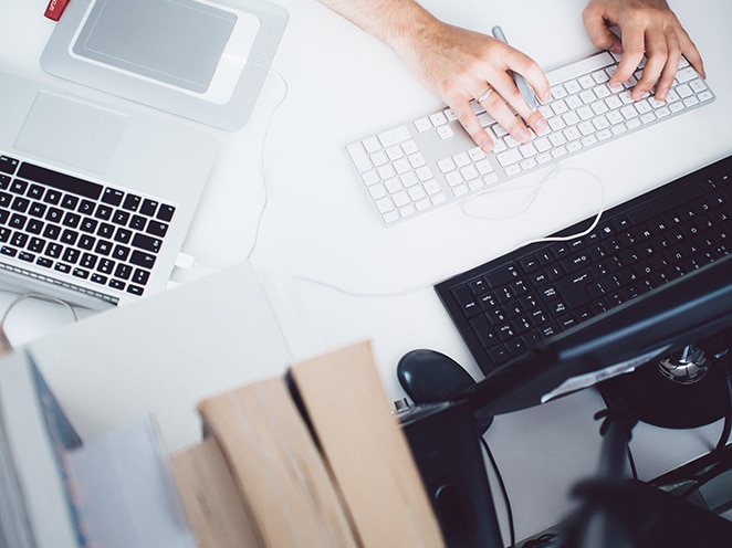 hands typing on a keyboard