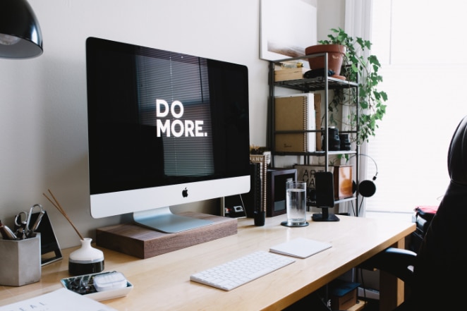 a computer on a desk says Do More