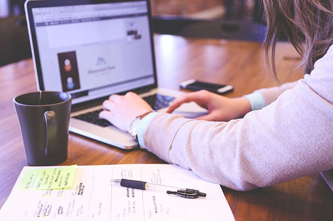 a woman works on a piece of content for her marketing strategy