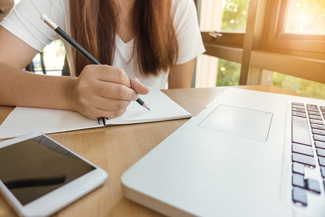 A professional woman working on web design and digital marketing strategies in her well-lit home office.