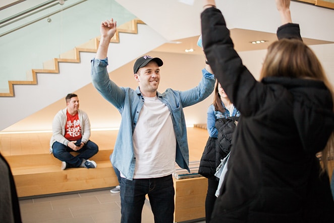 man with two fists in the air happy with person nearby