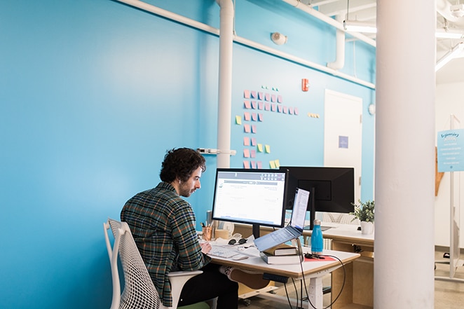 Man works on computer at desk